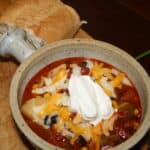 Chili In a Crock topped with cheese and sour cream