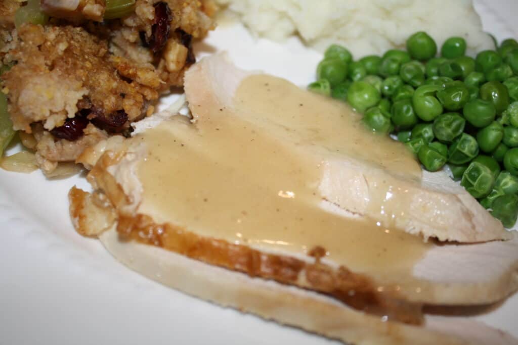 Never Fail Gravy over chicken with peas and stuffing.