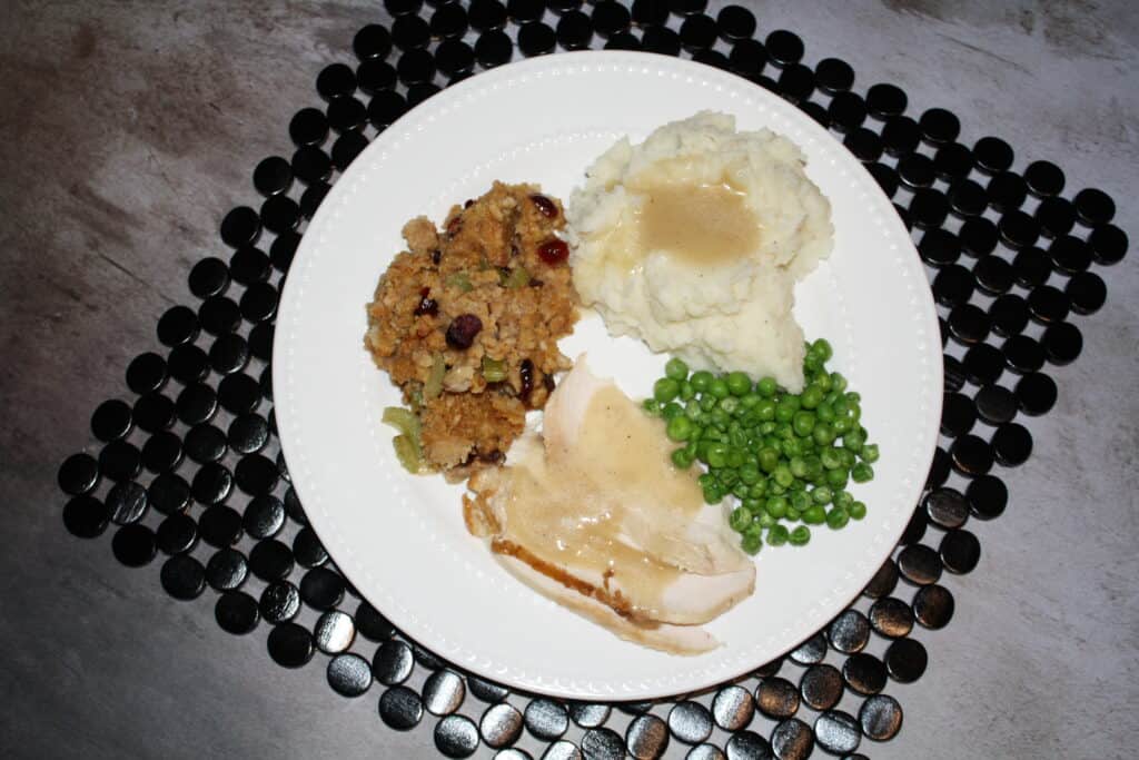 Chicken dinner with wardolf stuffing, mashed potatoes , peas and the best gravy!