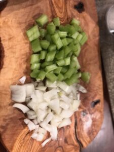 Chopped Onions and Celery on a wood cutting board