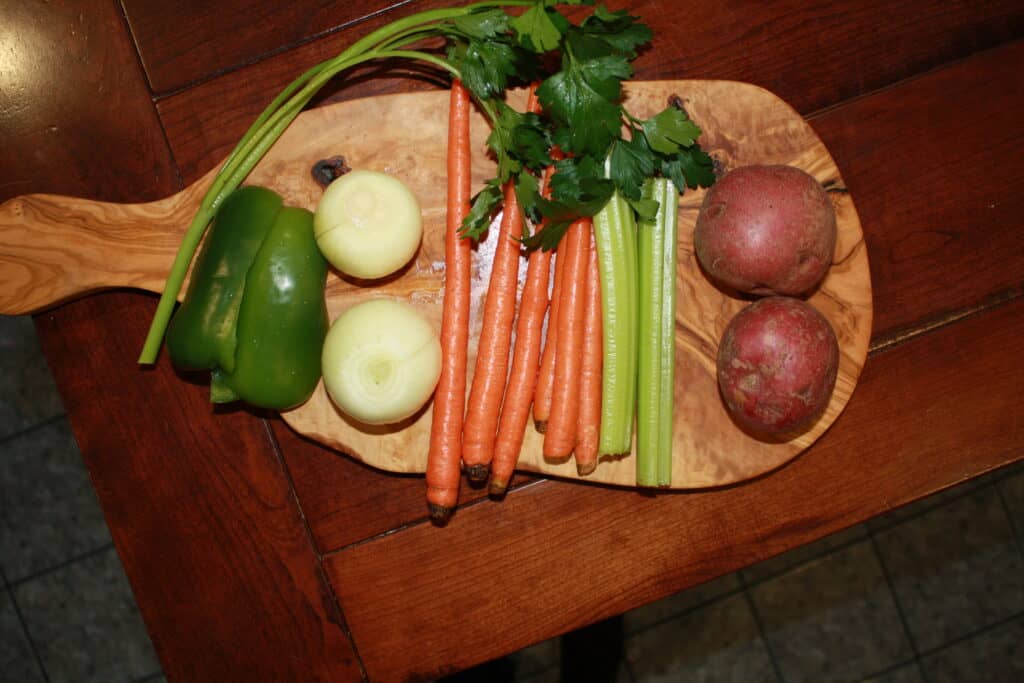 Veggies on a cutting Board. Peppers, Onion, Carrots , Celery and Potatoes