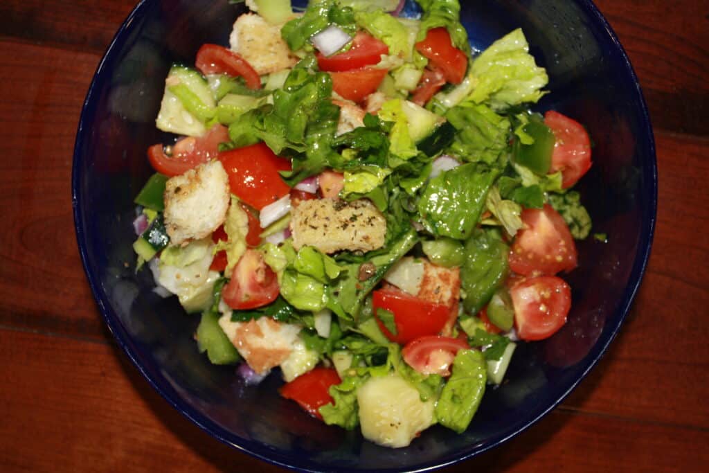 Panzanella salad in a blue bowl.