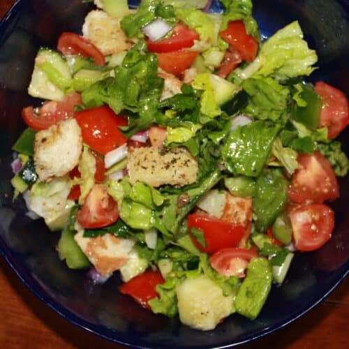 Panzanella salad in a blue bowl.