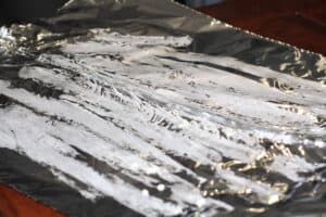 Tin foil sheets folded together for making a cooking pouch