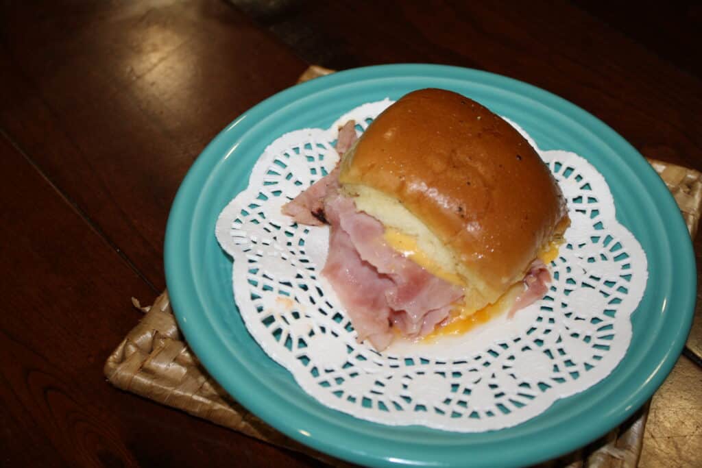 Ham and cheese slider sandwich on a plate.
