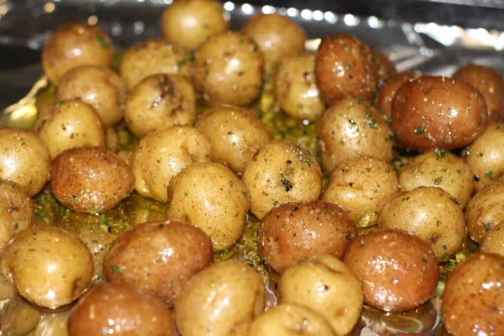 Tossed baby potatoes in olive oil and herbs