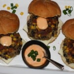 3 blackbean veggie burgers in rolls with cheese and chipotle mayo.