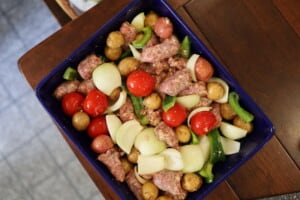 Oven Sausage Onion and Pepper in a blue casserole dish