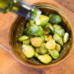 Adding truffle oil to brussels sprouts for roasting in the oven