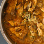 Easy Chicken Marsala in a sauce pan ready to serve over pasta.