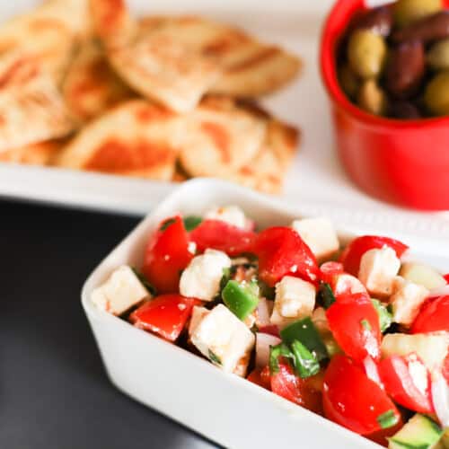 Mediterranean Greek Salad Dip with pita and olive over to the side