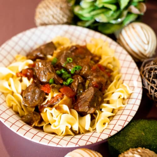 Hungarian Beef Goulash in a bowl over egg noodles