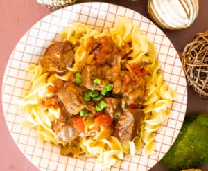 Hungarian Beef Goulash in a bowl over egg noodles