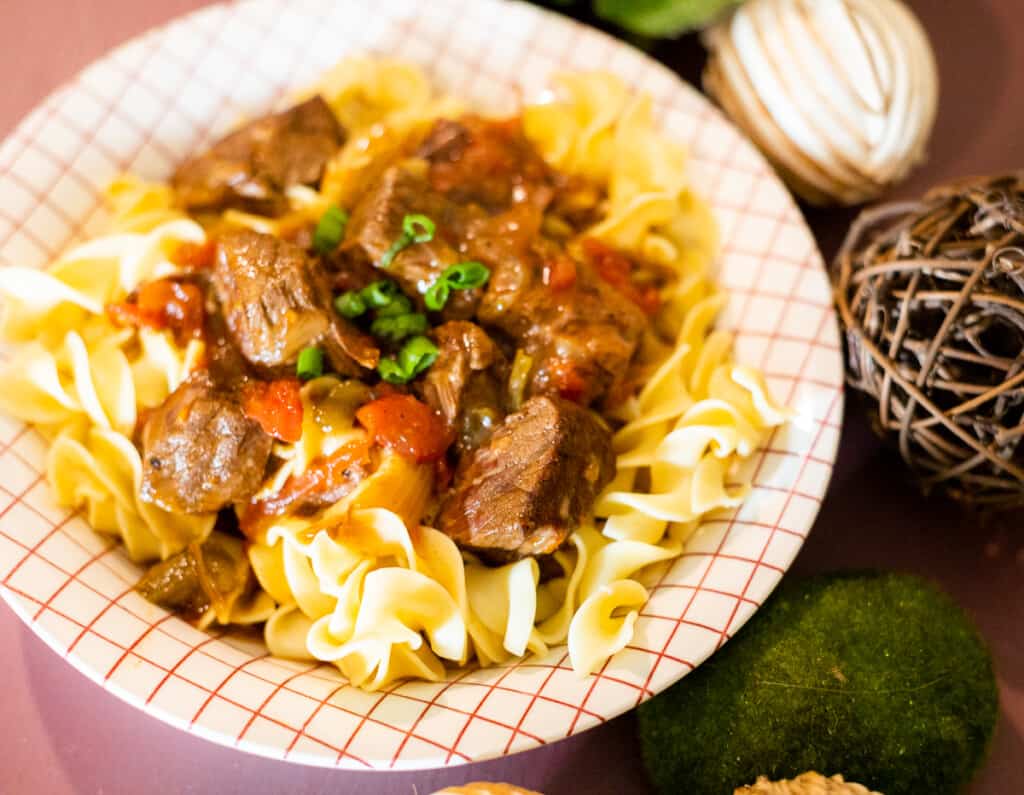 Hungarian Beef Goulash in a bowl over egg noodles
